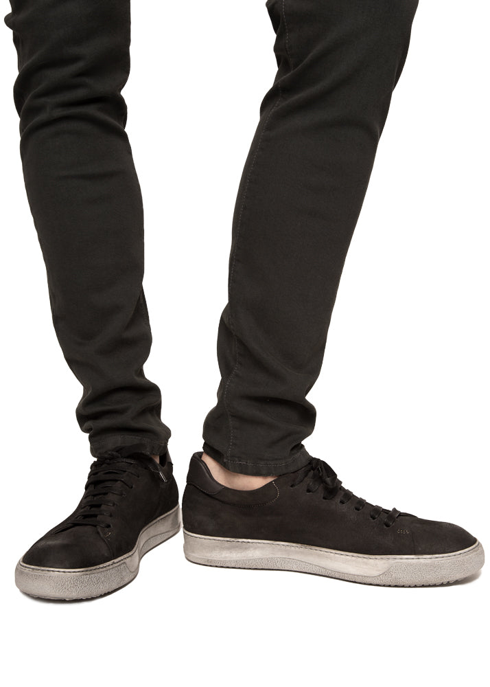 Side view on a model ARI Low Top Sneaker in Black Wash Suede. Made in Italy
