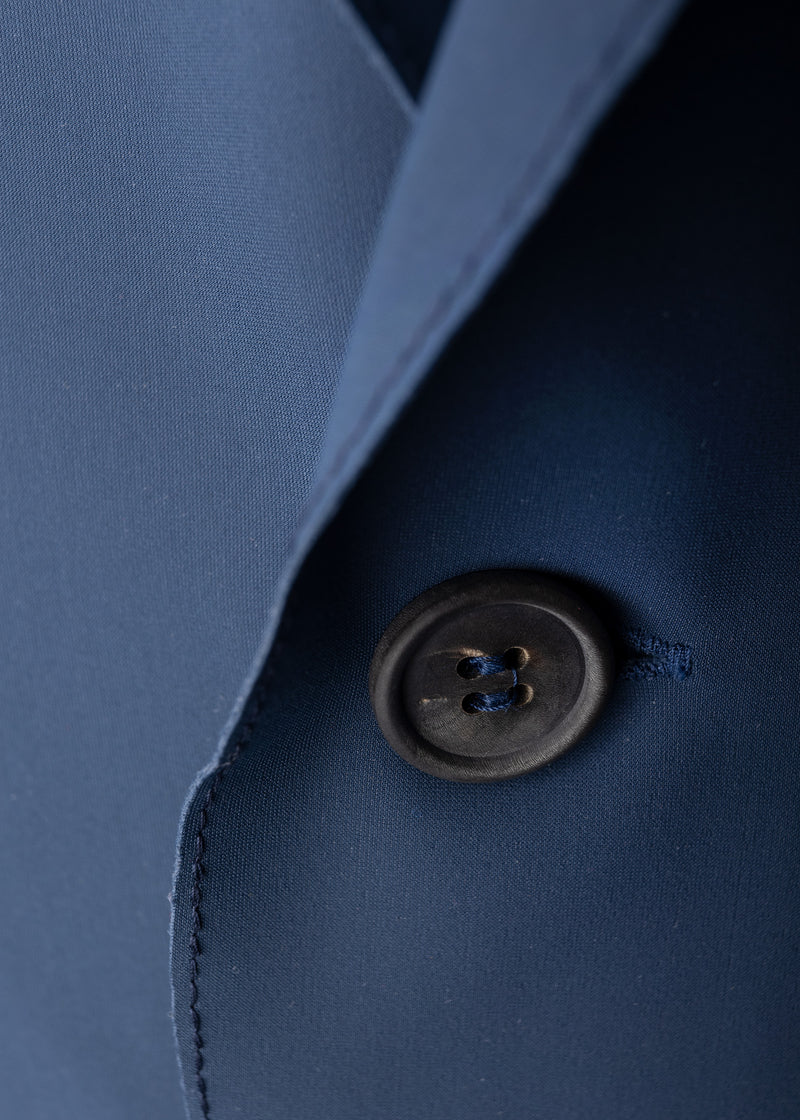 button view on lapel of ARI Live Cut Neoprene Blue Blazer. Made in Italy